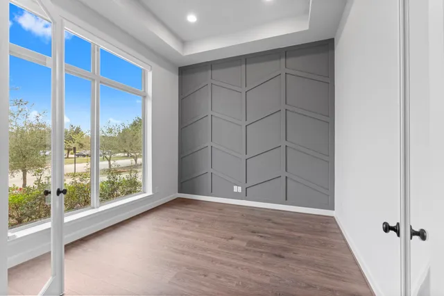 an empty room with wooden floor and sliding door