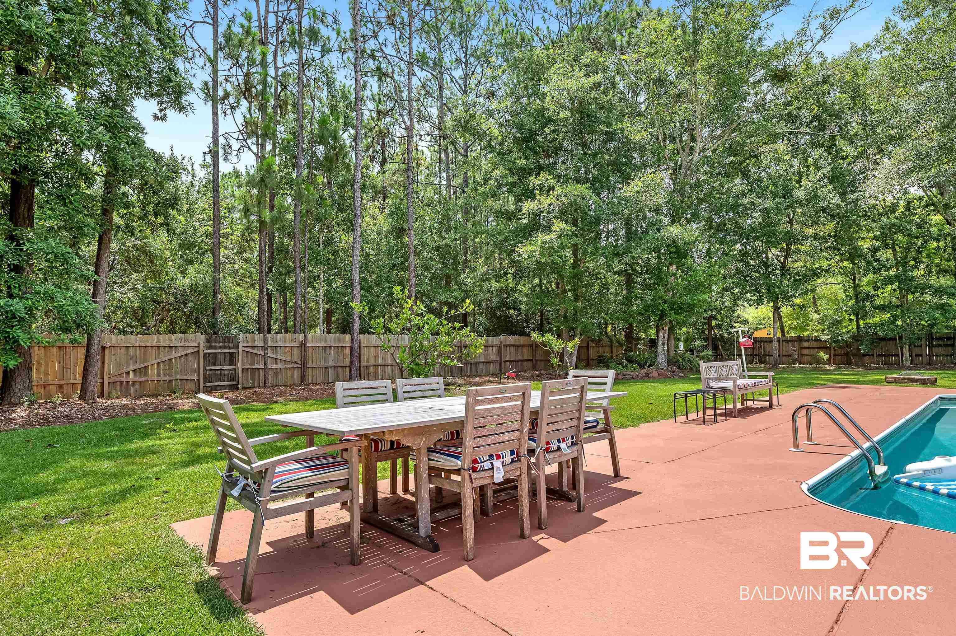 24551 Wolf Bay Drive Foley, AL 36535 - Photo 14 of 59 Fenced backyard with outdoor dining space and a patio area