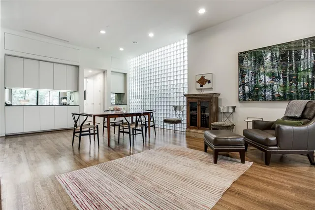 a living room with furniture a fireplace and a floor to ceiling window