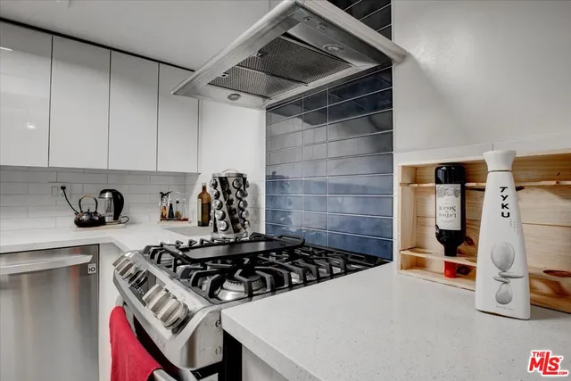 a kitchen with a stove and a refrigerator