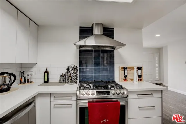 a kitchen with a stove and cabinets