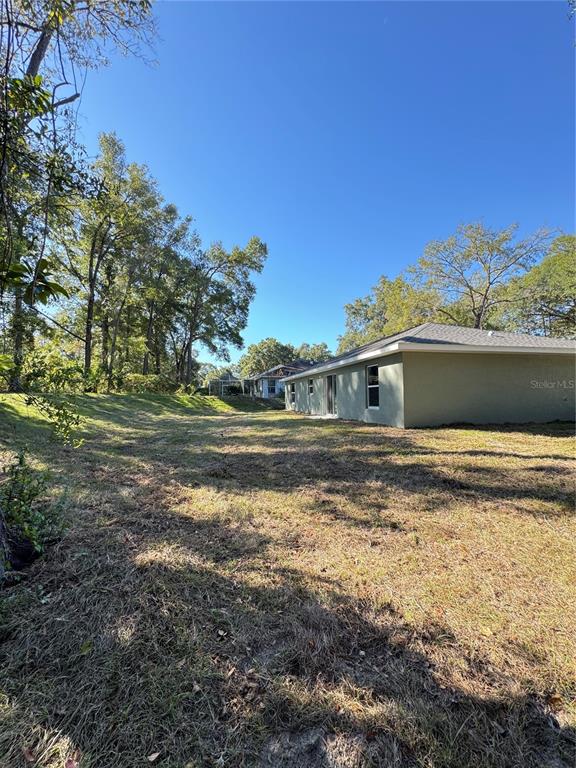 19330 Southwest 91st Loop Dunnellon, FL 34432 - Photo 17 of 46 a front view of a house with a yard