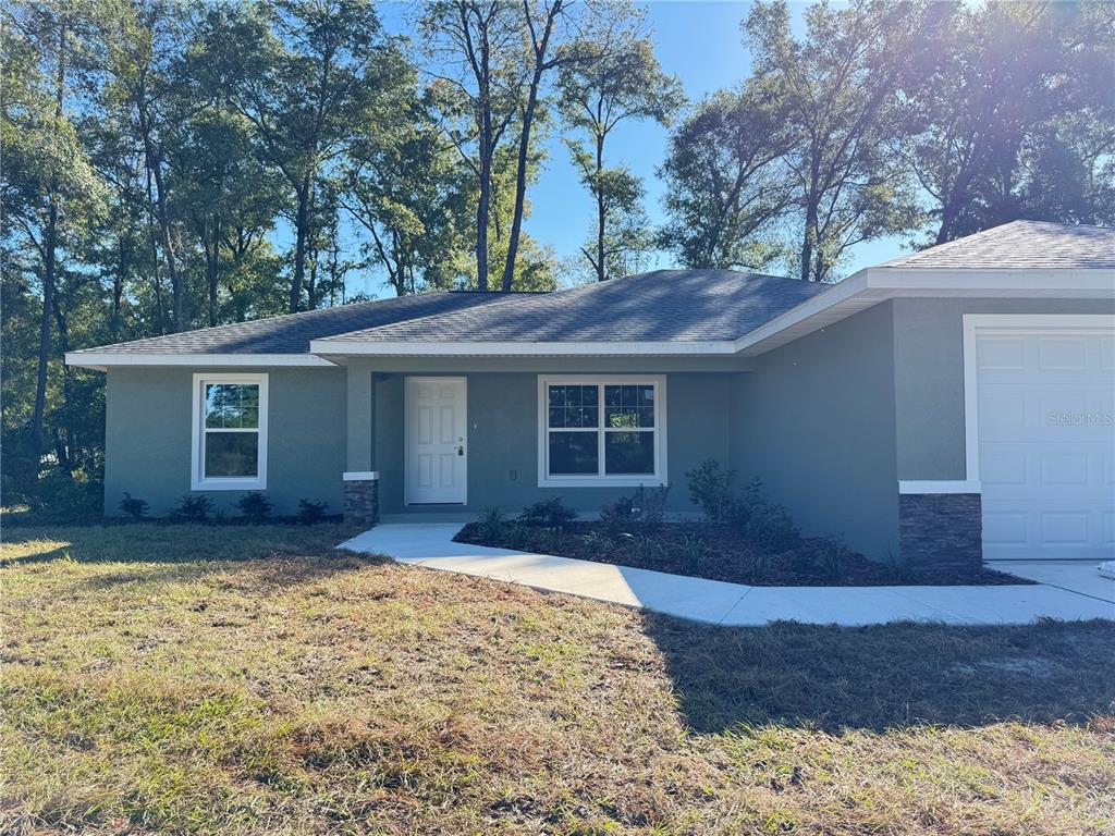 19330 Southwest 91st Loop Dunnellon, FL 34432 - Photo 4 of 46 a house that has a tree in front of it