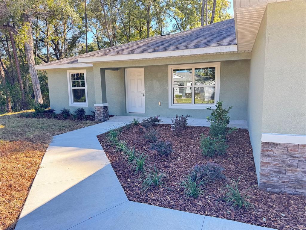 19330 Southwest 91st Loop Dunnellon, FL 34432 - Photo 5 of 46 a front view of house with yard and seating space