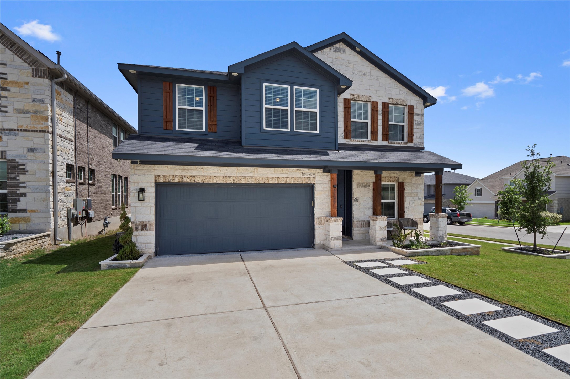 a front view of a house with yard and trees