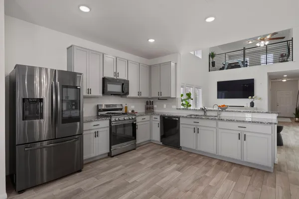 a kitchen with a sink stainless steel appliances and cabinets