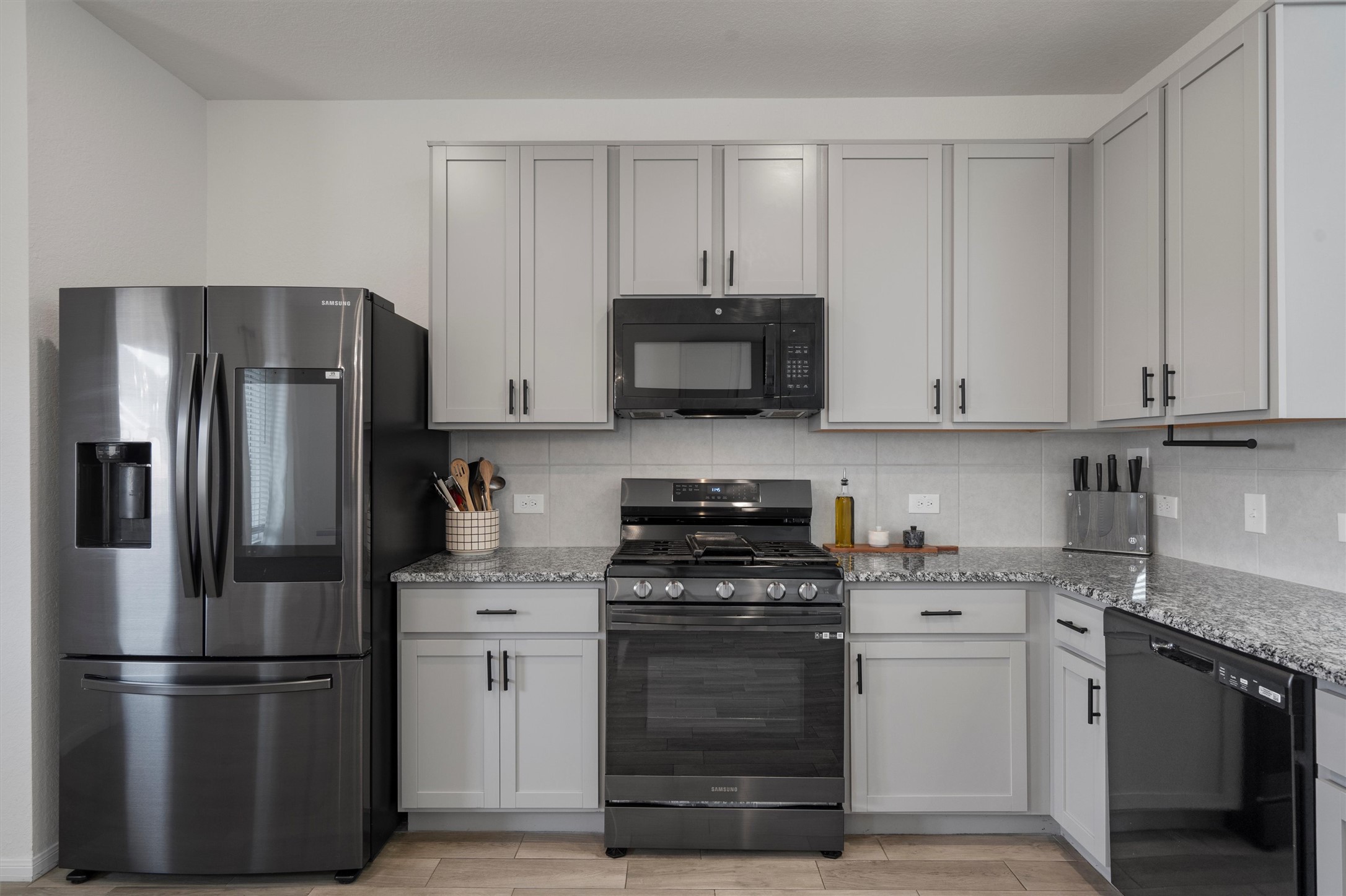 6720 Coalinga Lane Pflugerville, TX 78660 - Photo 14 of 38 a kitchen with stainless steel appliances granite countertop a refrigerator stove and sink with granite countertops