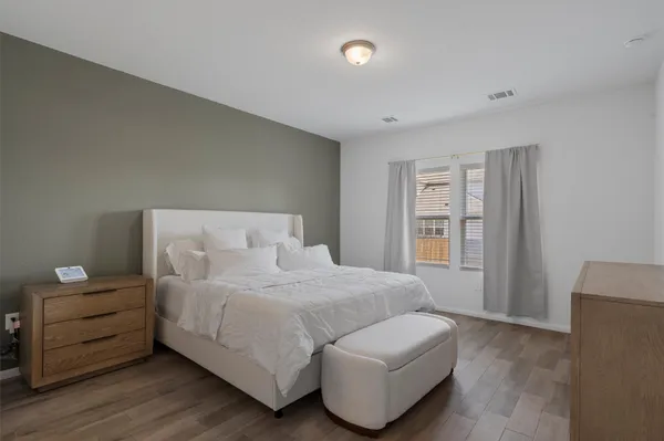 a bedroom with a bed and a couch