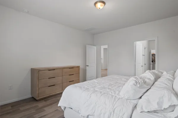 a bedroom with a bed and a dresser