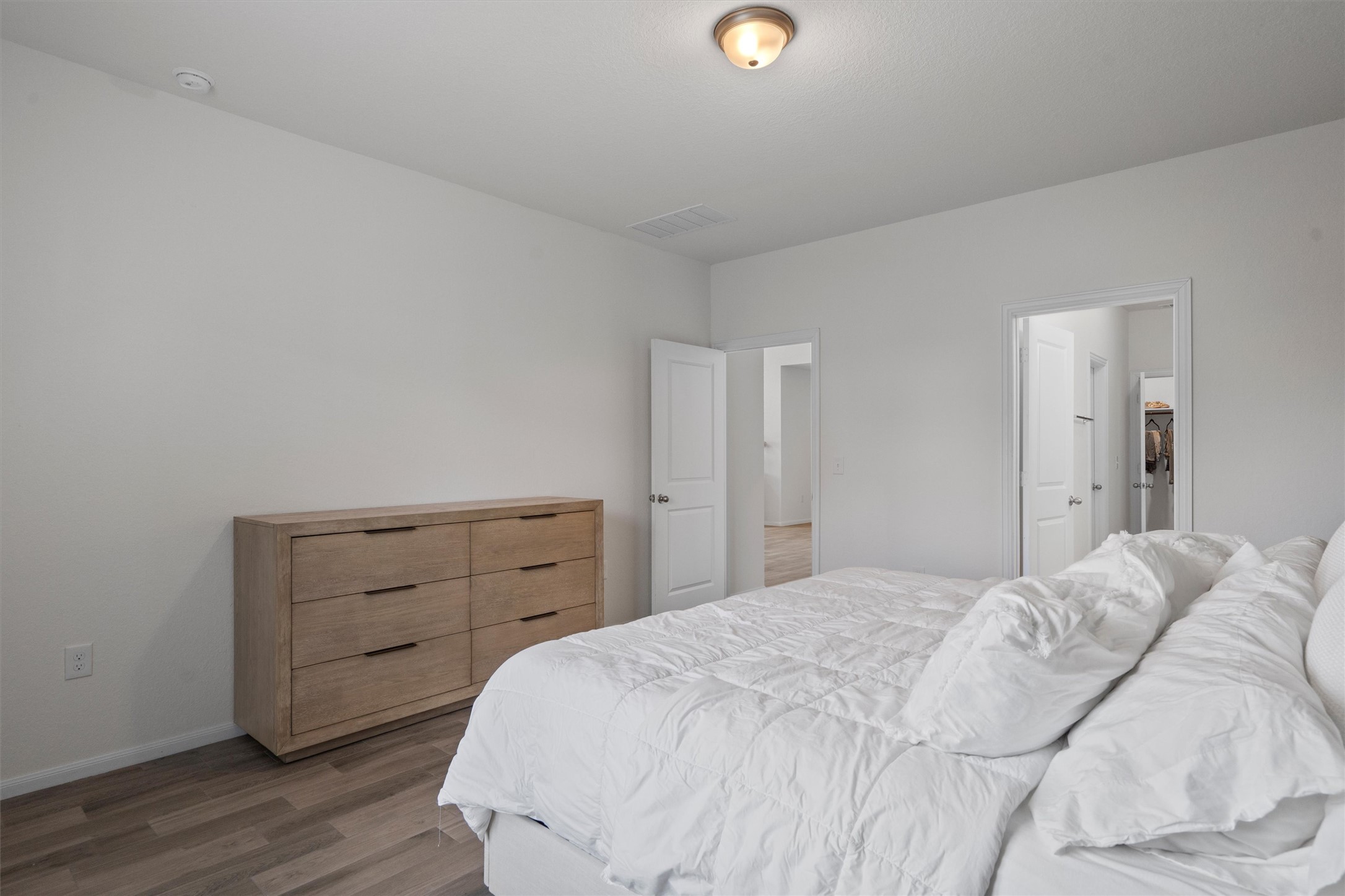 6720 Coalinga Lane Pflugerville, TX 78660 - Photo 18 of 38 a bedroom with a bed and a dresser