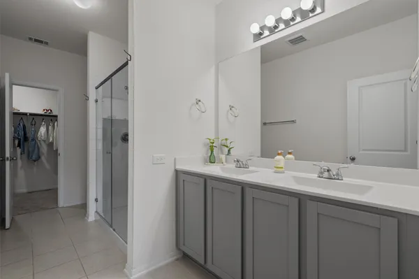 a bathroom with a double vanity sink and a mirror