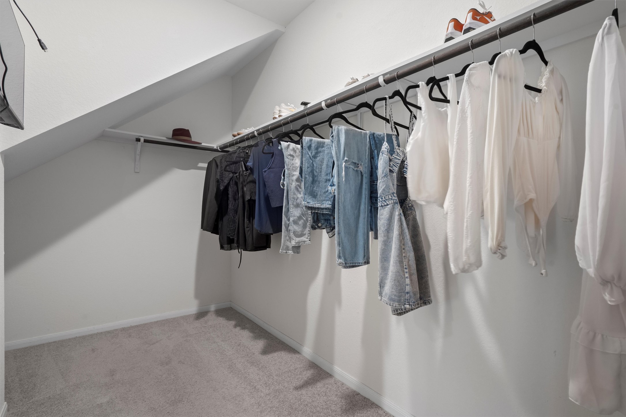 6720 Coalinga Lane Pflugerville, TX 78660 - Photo 21 of 38 a view of walk in closet with clothes