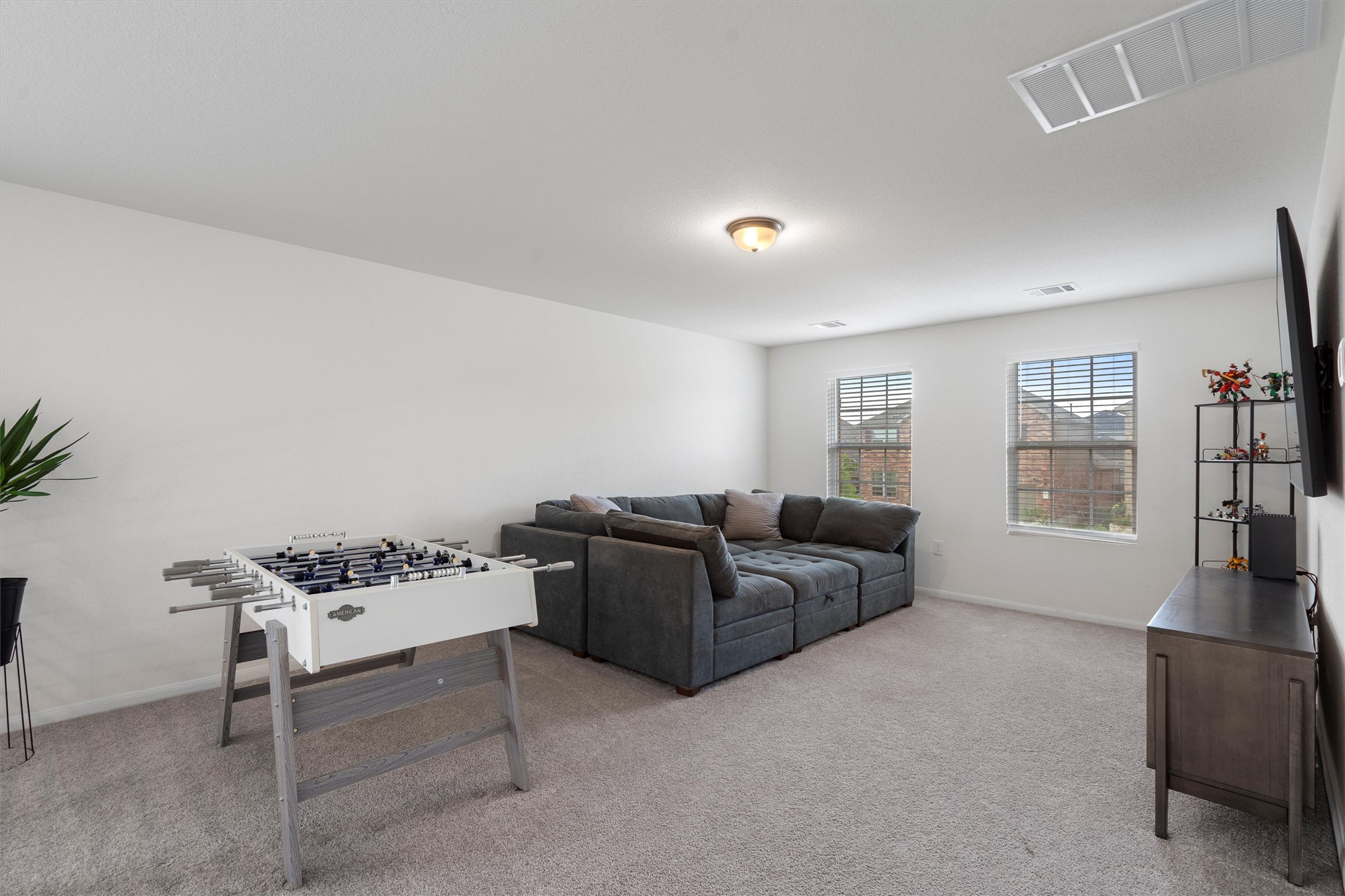 6720 Coalinga Lane Pflugerville, TX 78660 - Photo 24 of 38 a living room with furniture and a flat screen tv