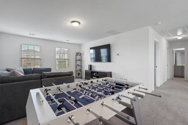 a living room with furniture a couch and a window