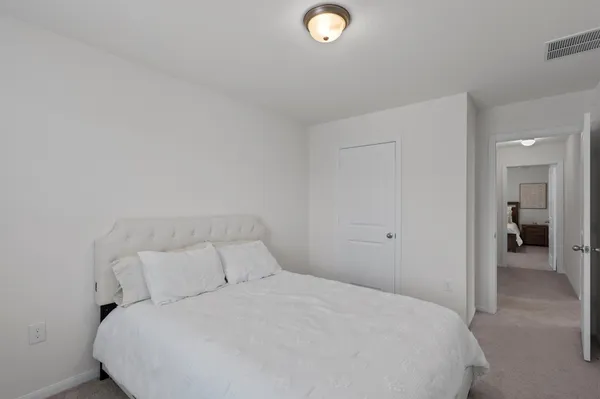 a large bed sitting in a bedroom and closet