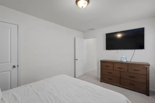 a bedroom with a bed and a flat screen tv