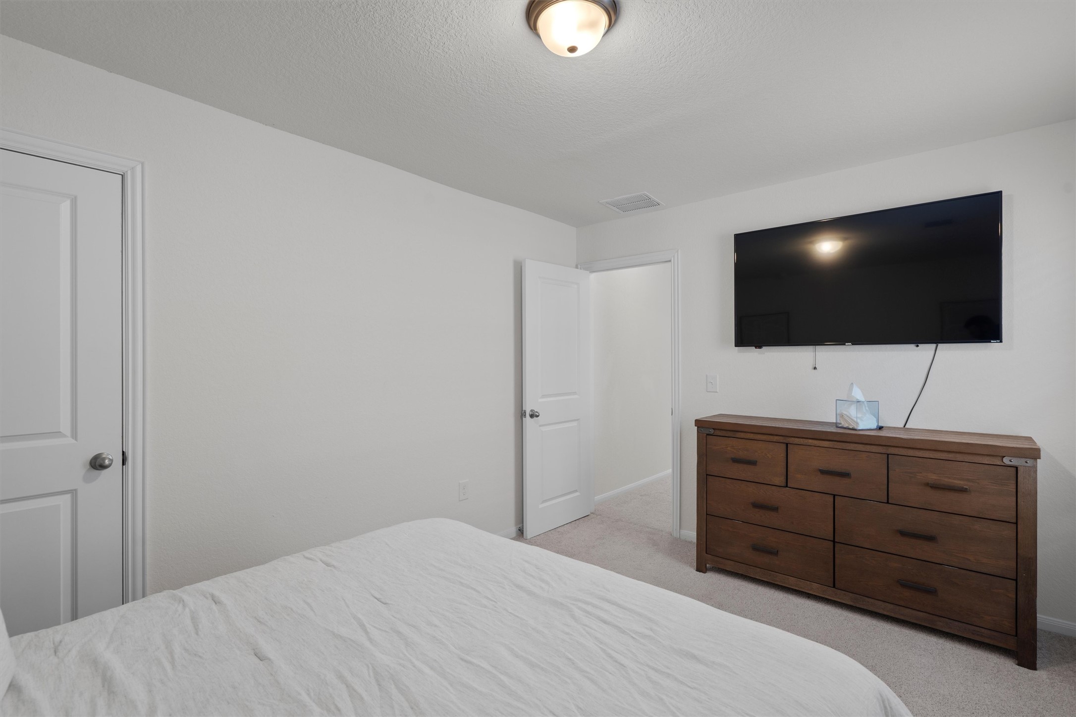 6720 Coalinga Lane Pflugerville, TX 78660 - Photo 32 of 38 a bedroom with a bed and a flat screen tv