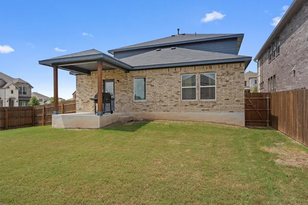 a view of a house with a backyard and a tub