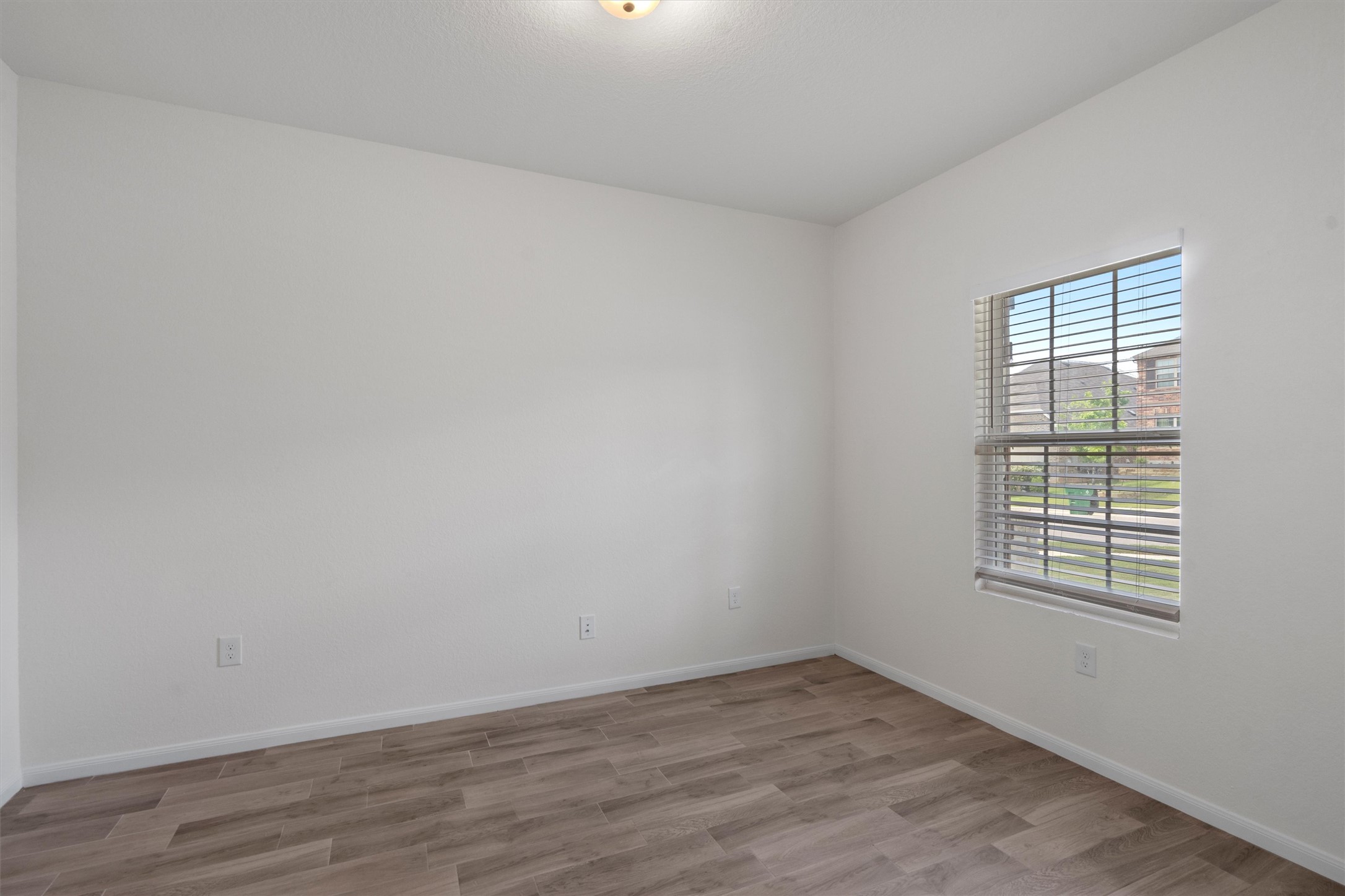 6720 Coalinga Lane Pflugerville, TX 78660 - Photo 5 of 38 an empty room with wooden floor and windows