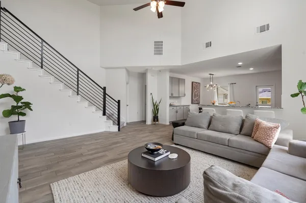 a living room with furniture and a wooden floor