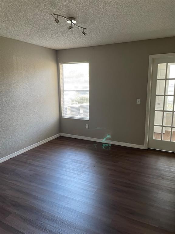 5148 Conroy Road, Unit 1214 Orlando, FL 32811 - Photo 14 of 16 an empty room with wooden floor and windows