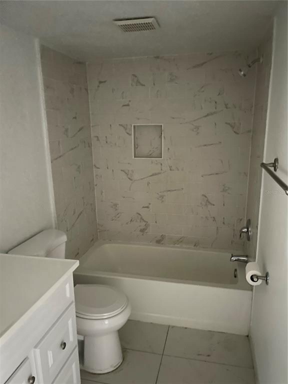 5148 Conroy Road, Unit 1214 Orlando, FL 32811 - Photo 16 of 16 a bathroom with a bathtub and toilet
