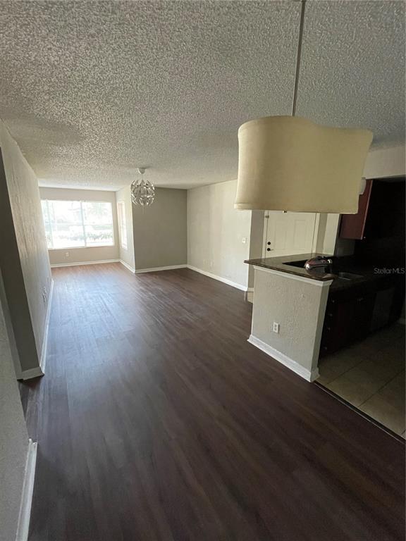 5148 Conroy Road, Unit 1214 Orlando, FL 32811 - Photo 7 of 16 a view of a kitchen with wooden floor and a sink
