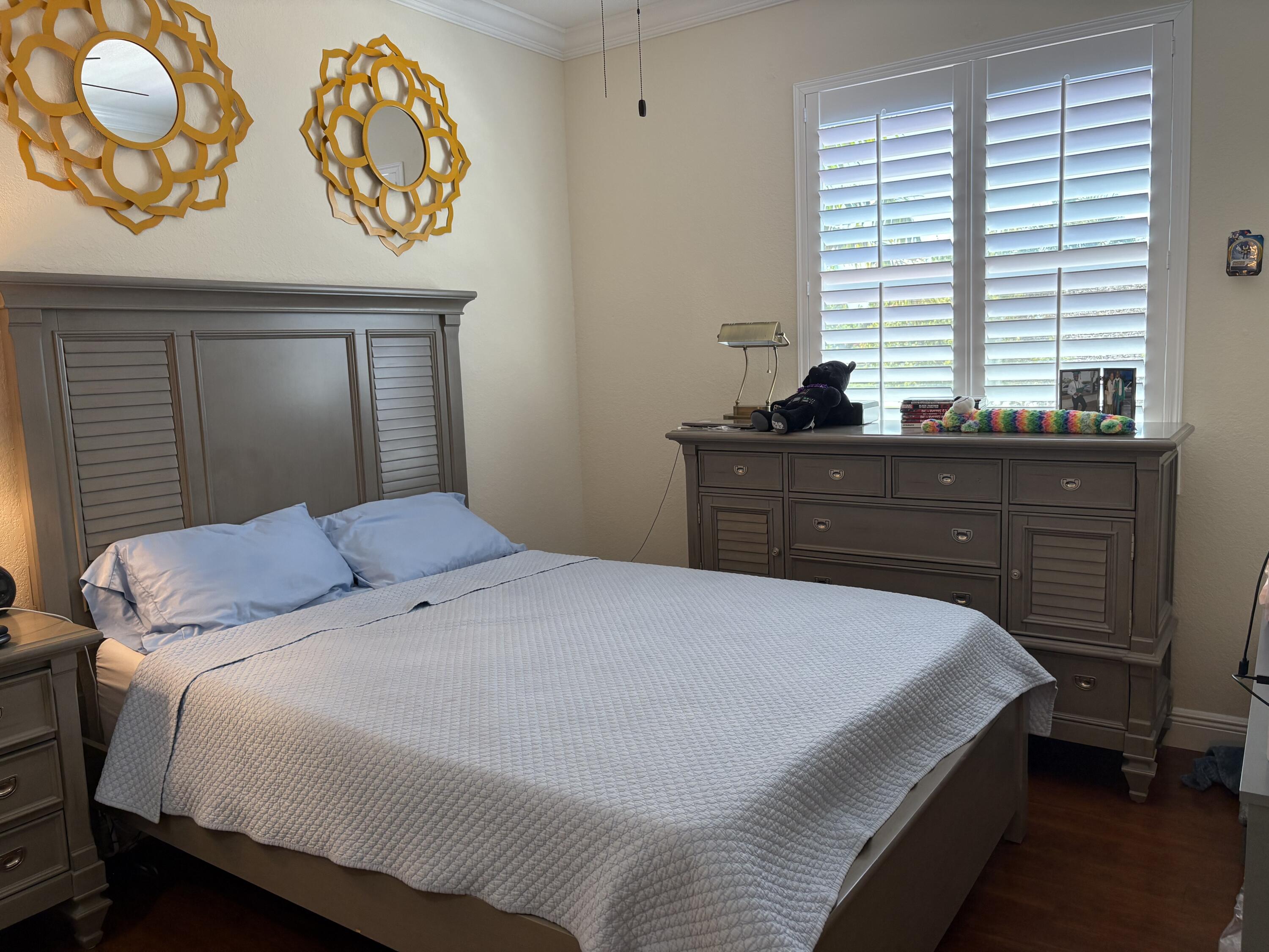 344 Lake Monterey Circle Boynton Beach, FL 33426 - Photo 13 of 14 a bedroom with a bed and a window