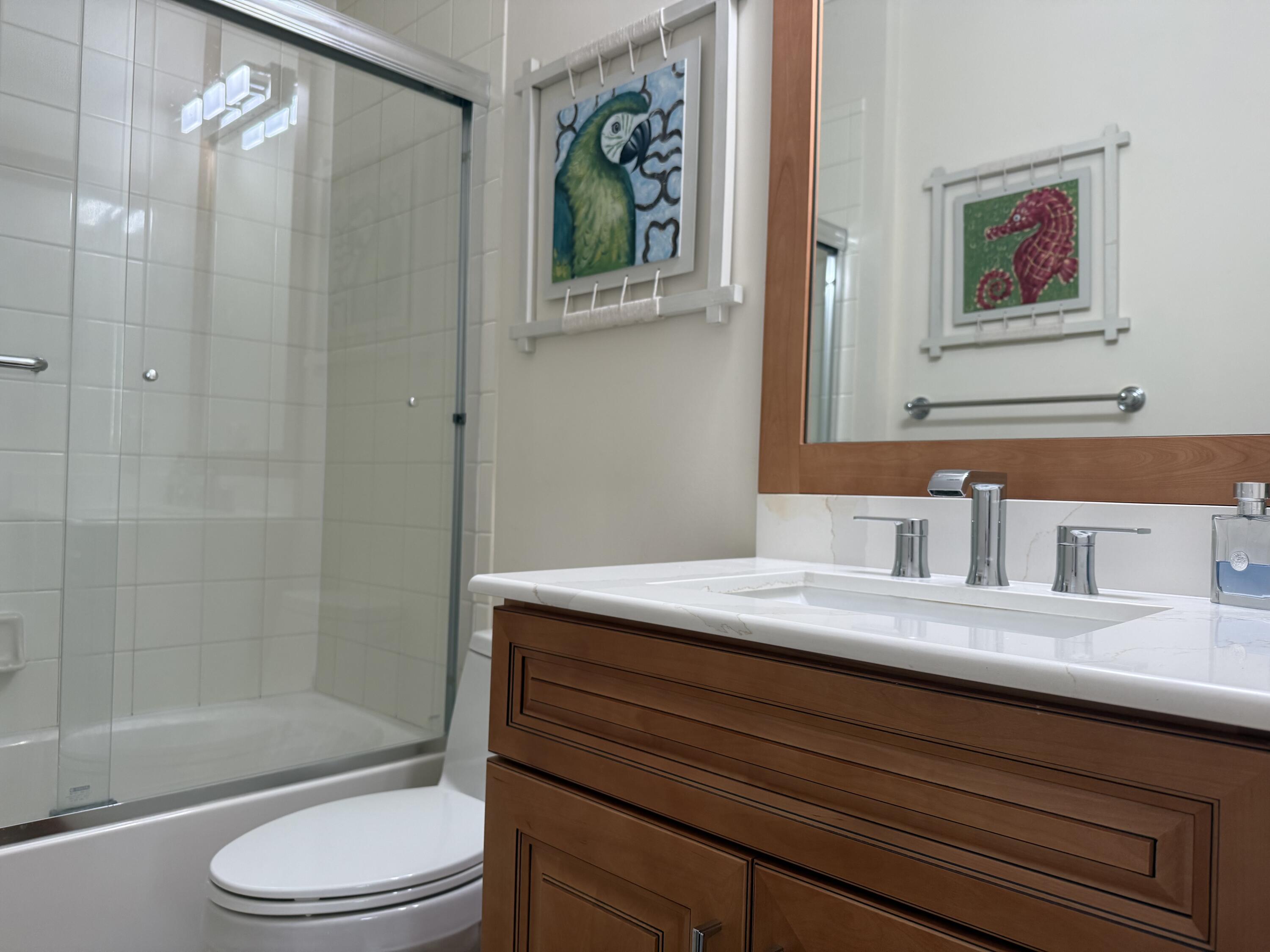 344 Lake Monterey Circle Boynton Beach, FL 33426 - Photo 14 of 14 a bathroom with a granite countertop sink a toilet and shower