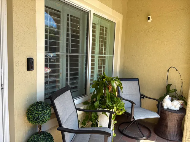a living room with furniture and potted plant