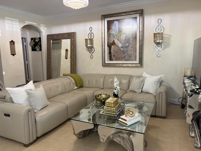 a living room with furniture and painting on the wall