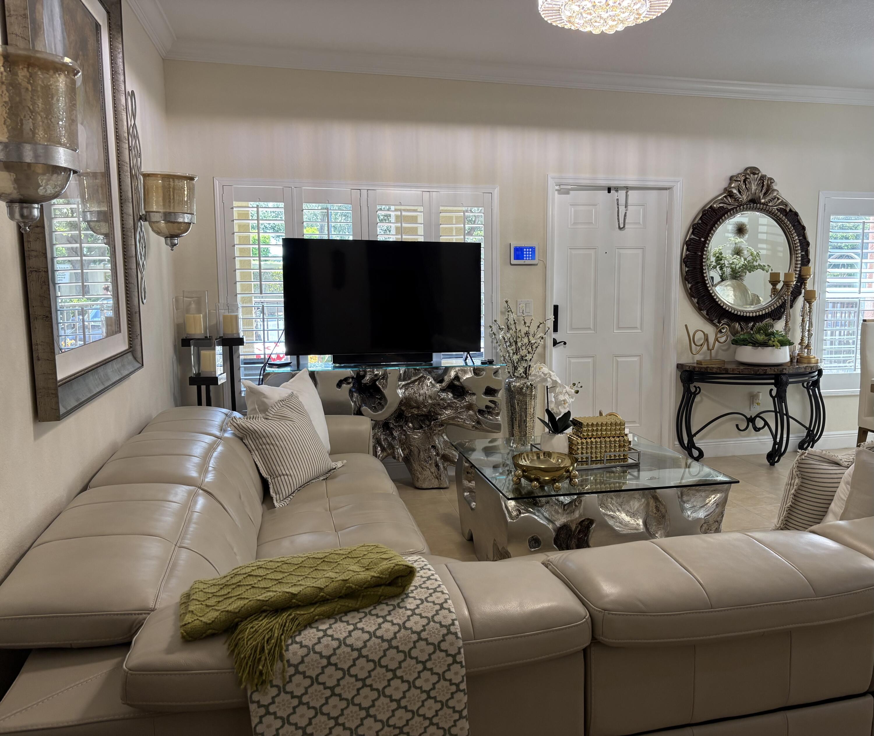 344 Lake Monterey Circle Boynton Beach, FL 33426 - Photo 4 of 14 a living room with furniture a flat screen tv and a fireplace