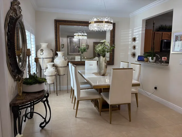 a view of a dining room with furniture and chandelier
