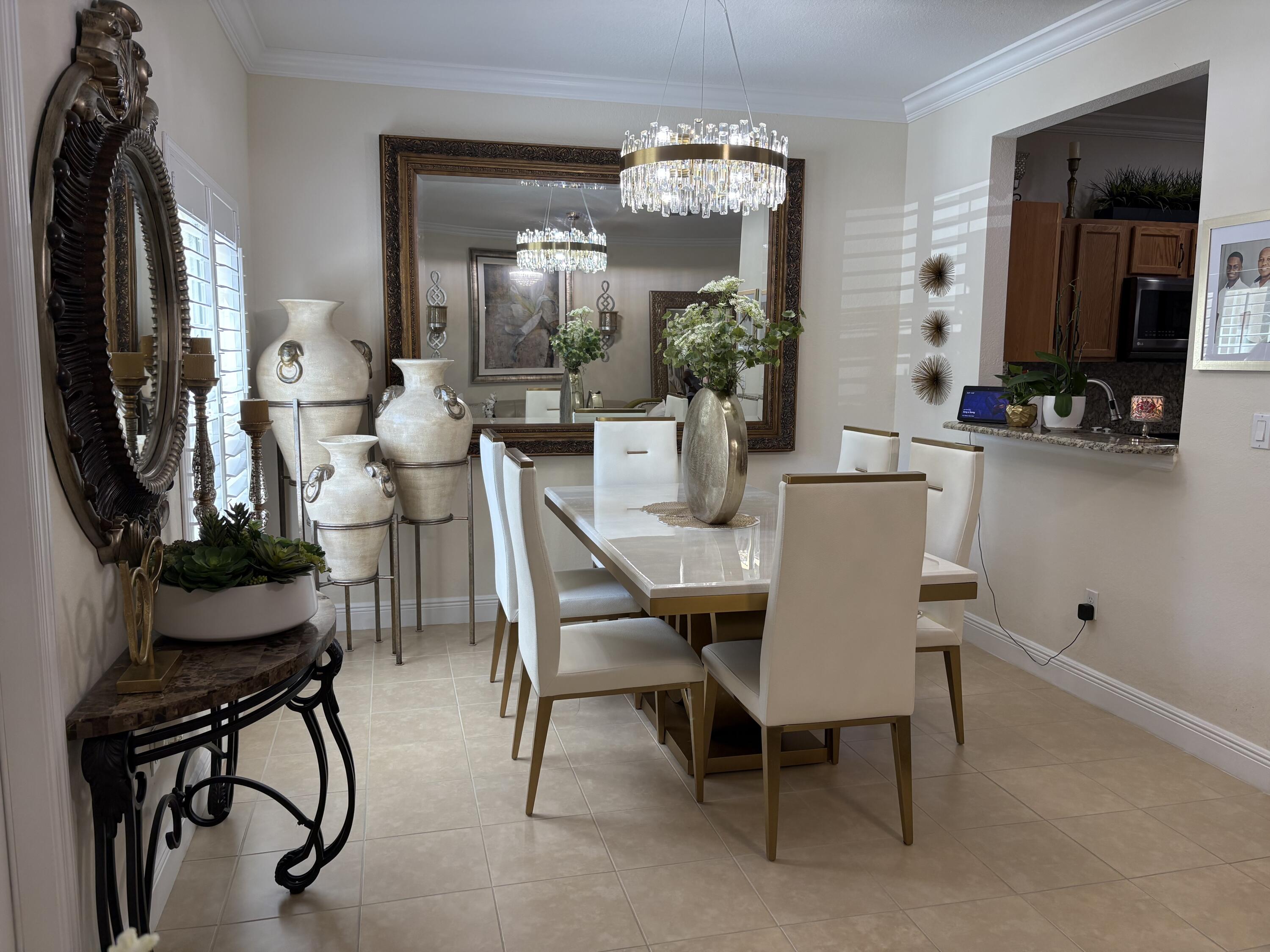 344 Lake Monterey Circle Boynton Beach, FL 33426 - Photo 5 of 14 a view of a dining room with furniture and chandelier