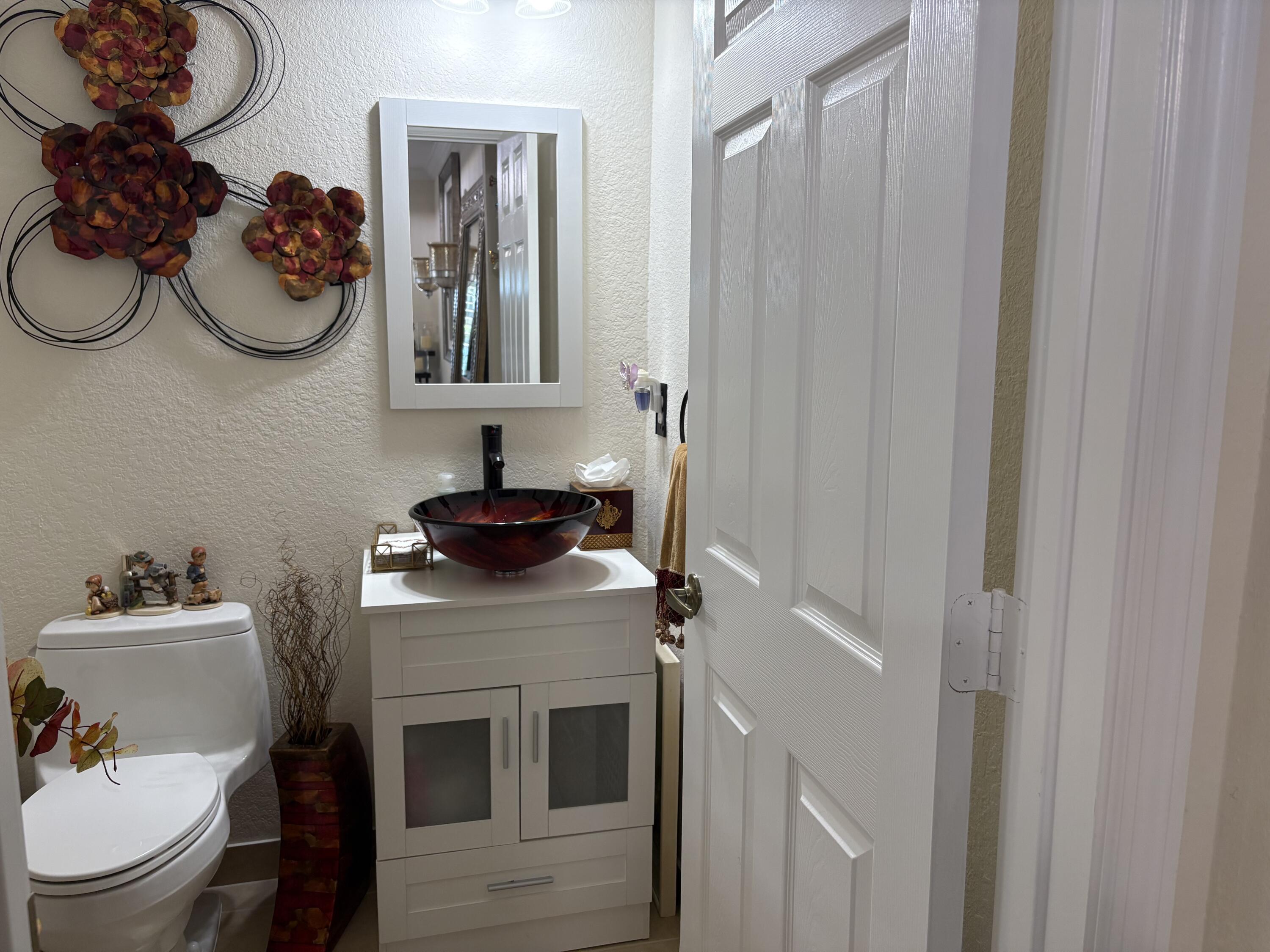 344 Lake Monterey Circle Boynton Beach, FL 33426 - Photo 7 of 14 a bathroom with a sink vanity mirror and toilet