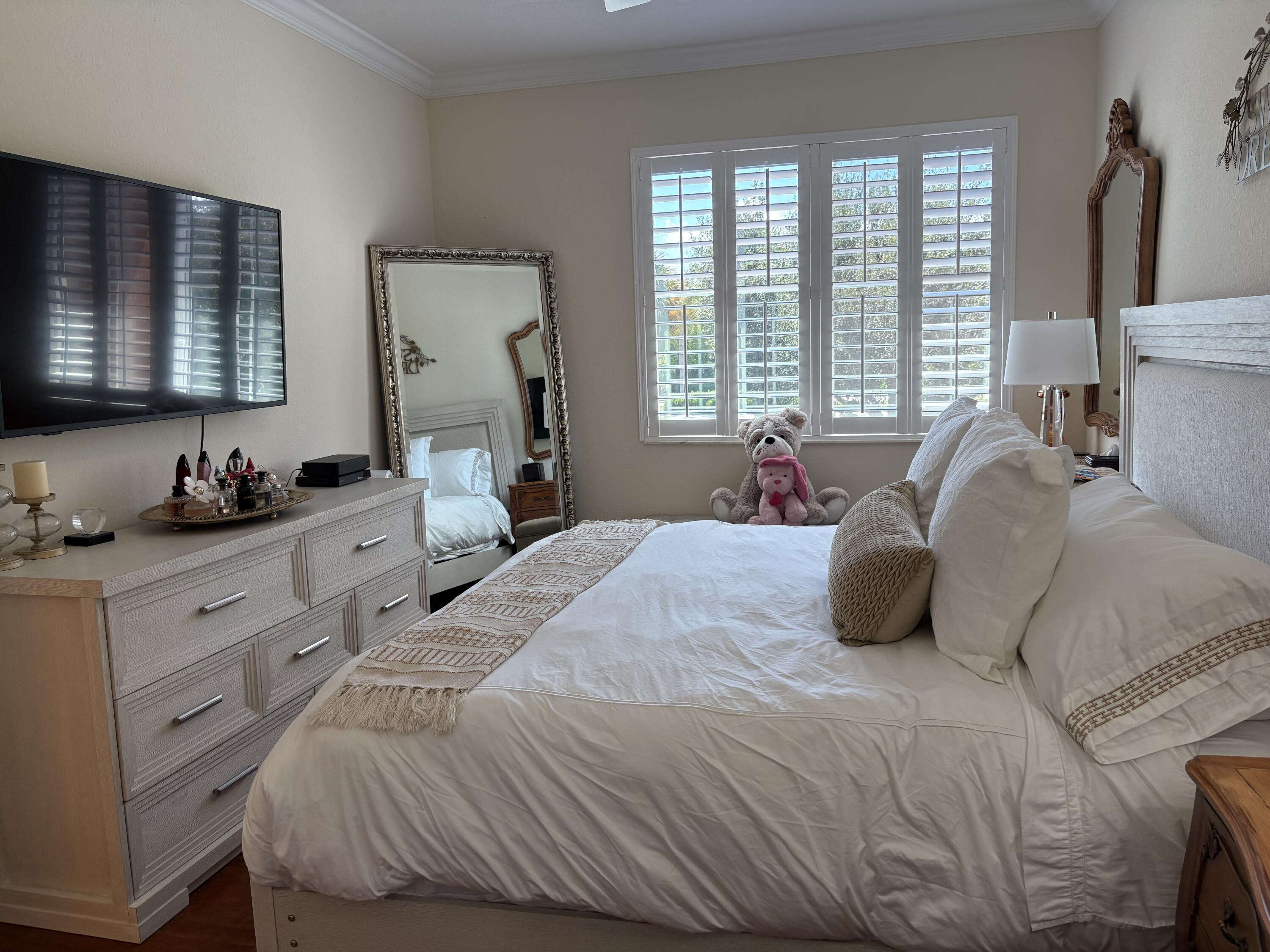 344 Lake Monterey Circle Boynton Beach, FL 33426 - Photo 10 of 14 a bedroom with a bed and a window