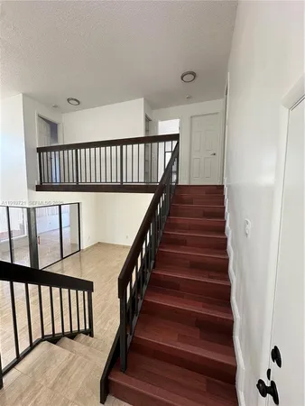 a view of staircase with wooden floor and a window