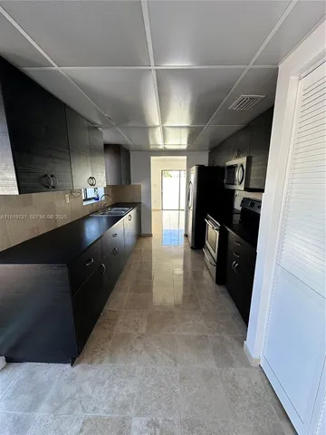 a kitchen with refrigerator and window
