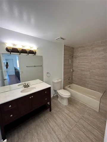 a bathroom with a double vanity sink and a toilet