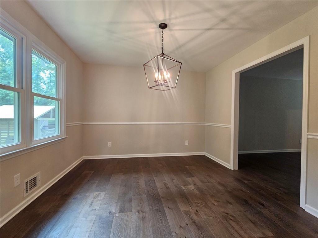 290 Oakmere Road Alpharetta, GA 30009 - Photo 8 of 26 an empty room with wooden floor and windows