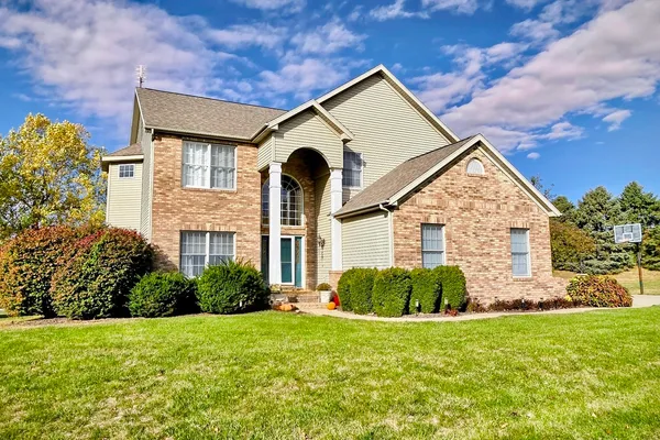 a front view of a house with garden