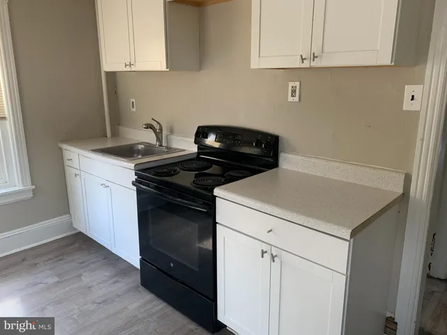 a kitchen with a stove and a white cabinet