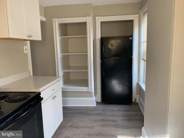 a view of an empty kitchen and a stove