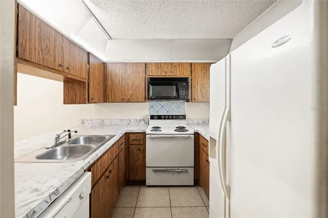 a kitchen with a sink cabinets and stainless steel appliances