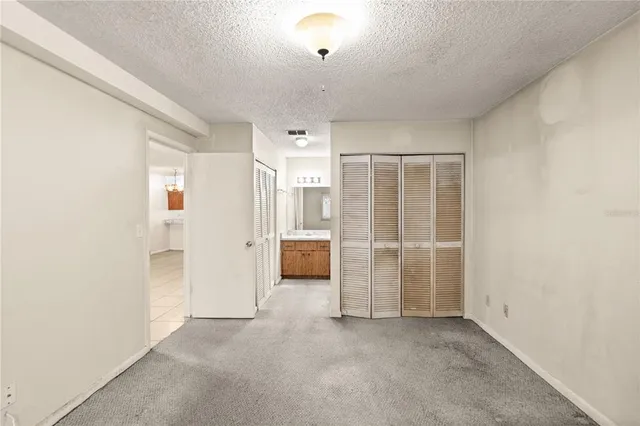 an empty room with a bathroom and a shower