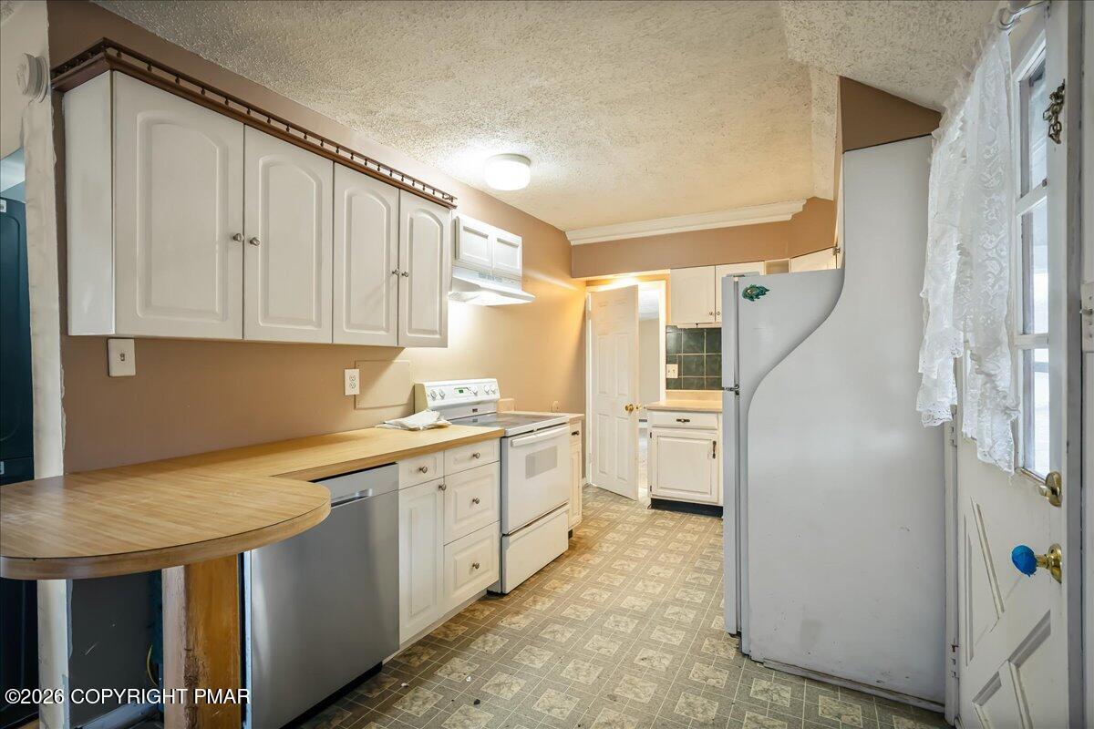 1191 Aberdeen Road Moscow, PA 18444 - Photo 8 of 19 a kitchen with a sink a refrigerator and cabinets