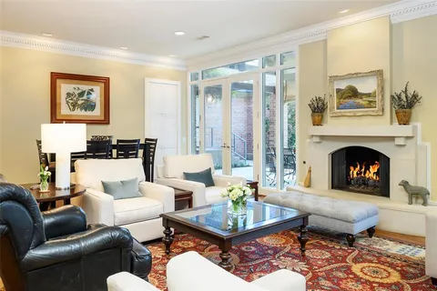 a living room with furniture fireplace and window
