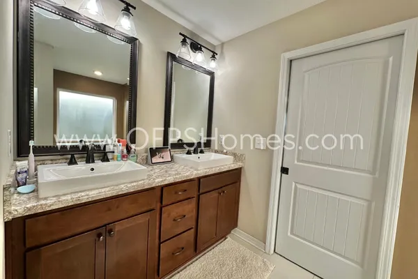 a bathroom with a tub sink and mirror
