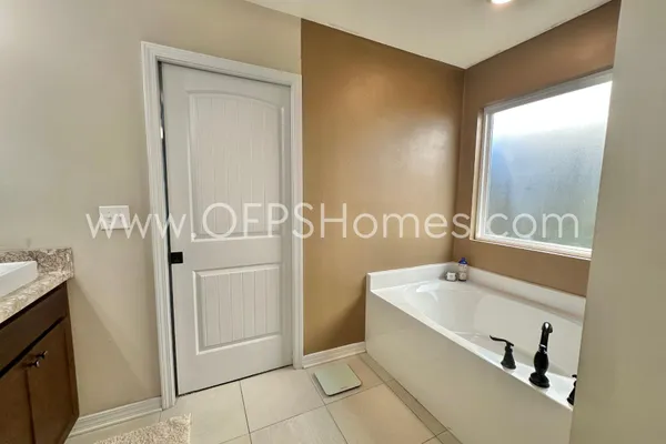 a bedroom with bed and window