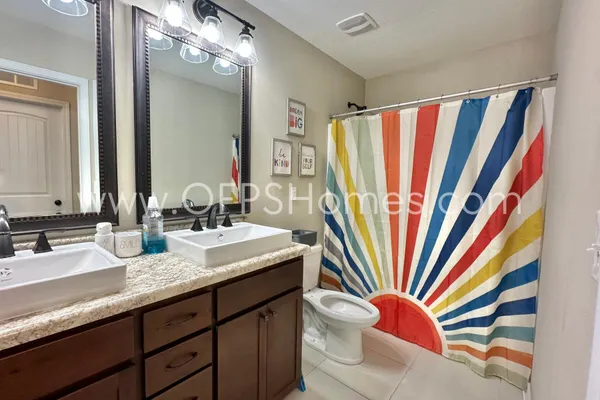 a bed room with a bed window and a dresser